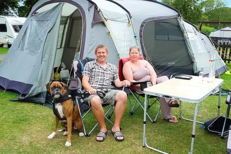 family and dog at campsite in dorset